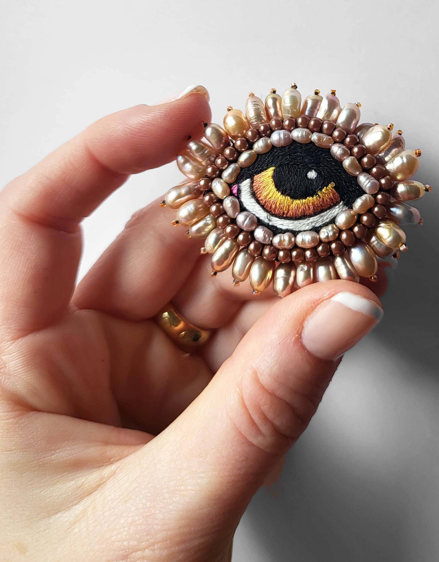 BAROQUE EYE BROOCH WITH FRESHWATER PEARLS